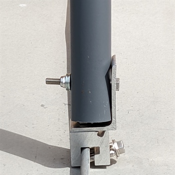 Non-penetrating metal roof clamp