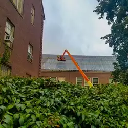 Efficient snow retention system shown as metal roof snow bars, chosen by SUNY College