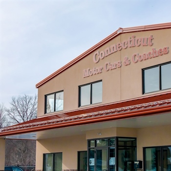 Installing AceClamp metal roof ice guards on Connecticut Motor Cars building