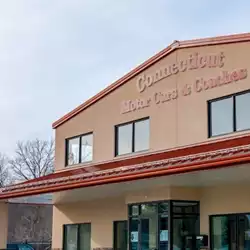 Installing AceClamp metal roof ice guards on Connecticut Motor Cars building