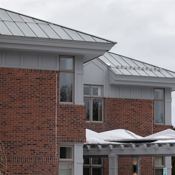 AceClamp snow bars installed on metal roof for snow retention