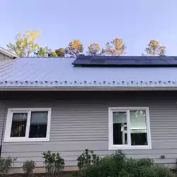 Durable metal roof featuring AceClamp snow bars for winter protection.