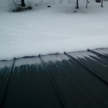 AceClamp 2-Bar metal roof ice guards installed on a metal roof in Stonington, CT.