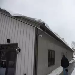 Easy to install snow guards protecting walkways from falling snow.