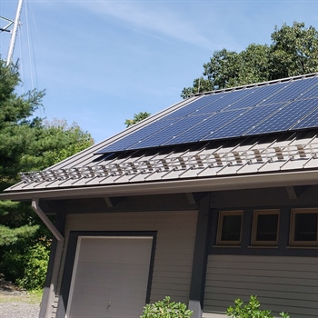 Close-up of AceClamp solar panel snow guards on a rooftop